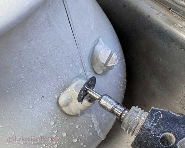 Using a diamond disc cutting a slot for copper pegs under running water