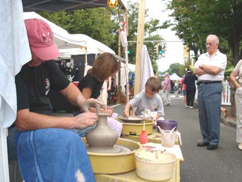 Stamford, Southern CT Art and Craft fair with children and adults trying pottery