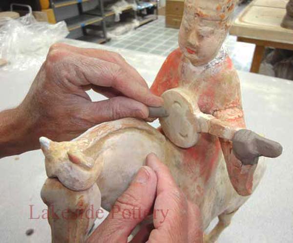 Stone sculpture repair using pins and pegs for mechanical integrity