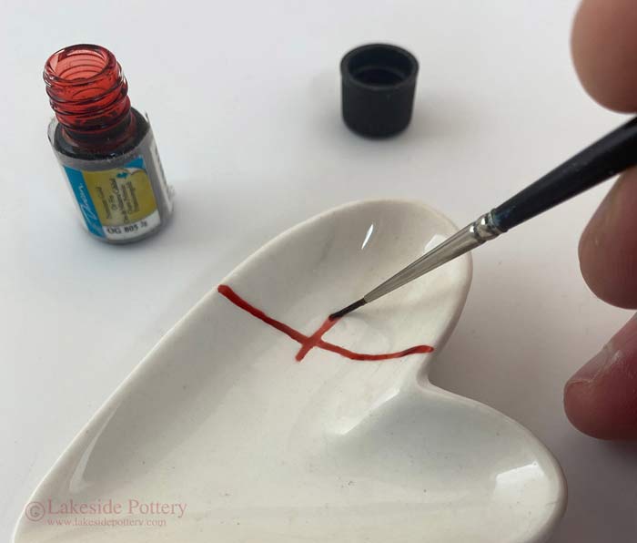 Brushing on Duncan OG 805 Premium Gold overglaze fired to about 1,300 degrees F (cone 18).