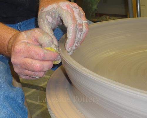 turn whell slowly and raise wall with rib tools to avoid too much water