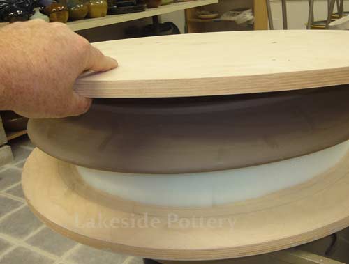 place another wooden bat on top and flip over